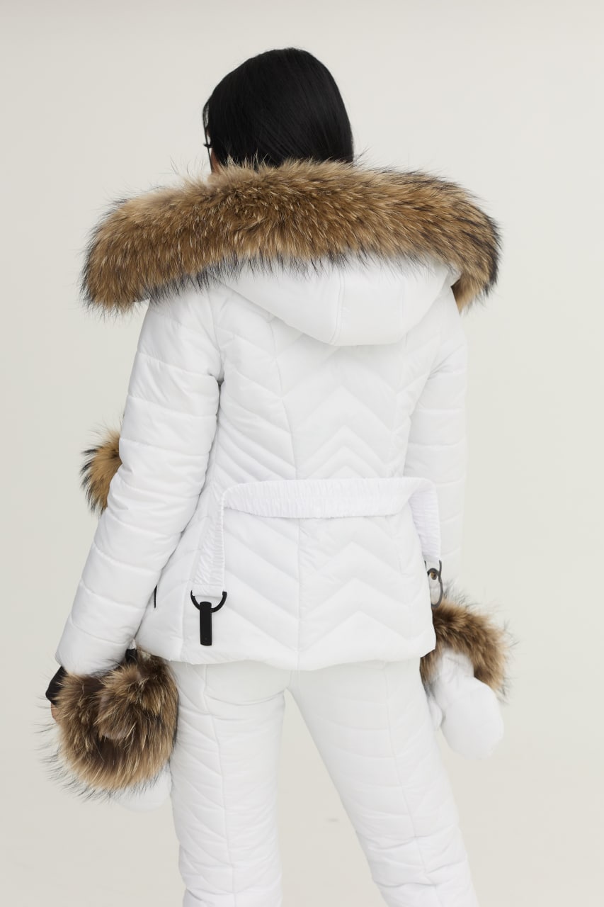 White winter coat with fur hood and cuffs on a neutral background