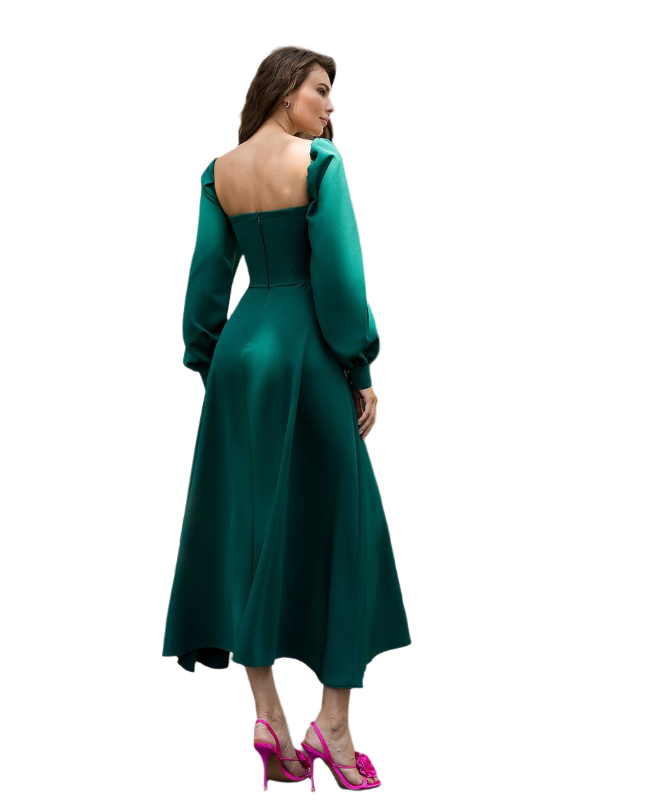 Woman wearing a green dress with a fitted bodice and flared skirt on a white background