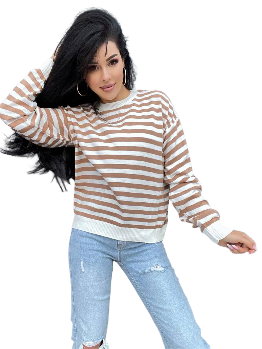 Woman wearing a brown and white striped sweater and light blue jeans on a white background