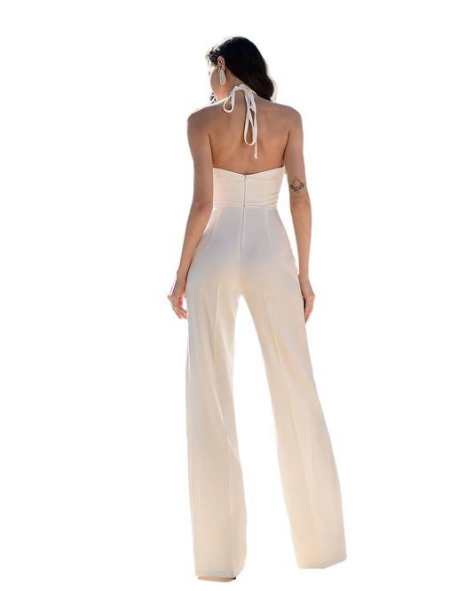 Woman wearing a white halter neck jumpsuit on a white background