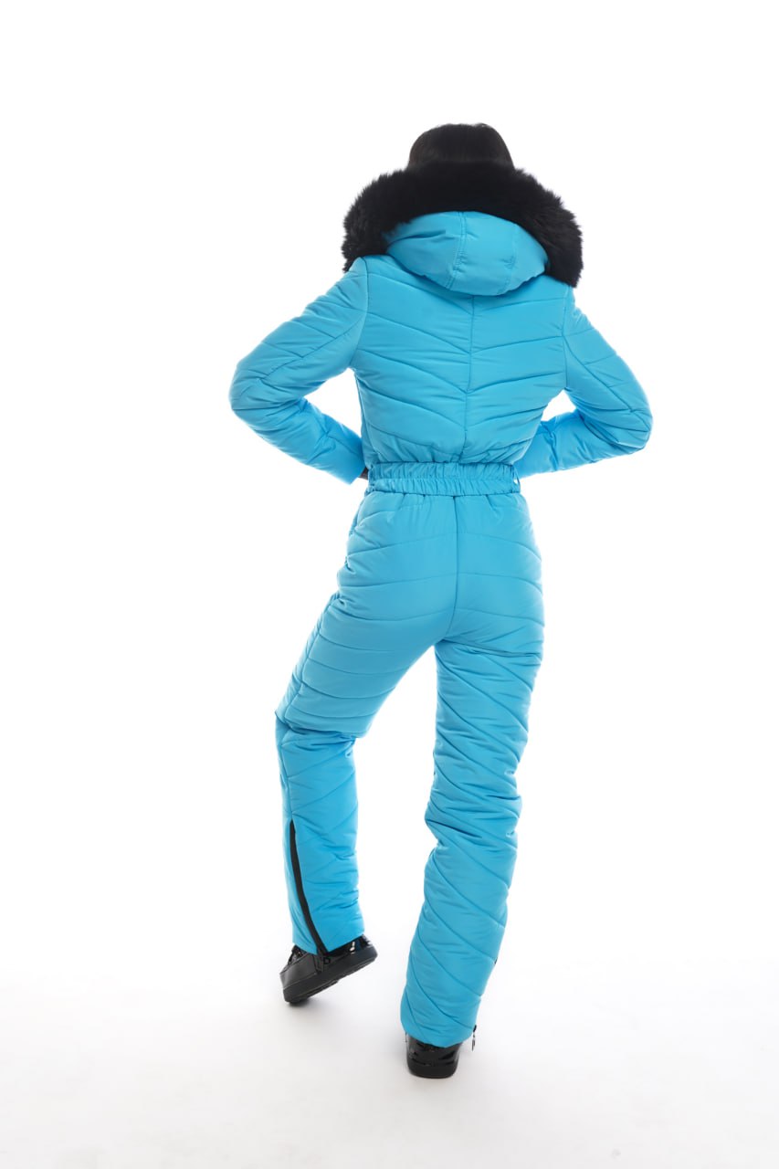 Blue snowsuit with black fur hood on a white background