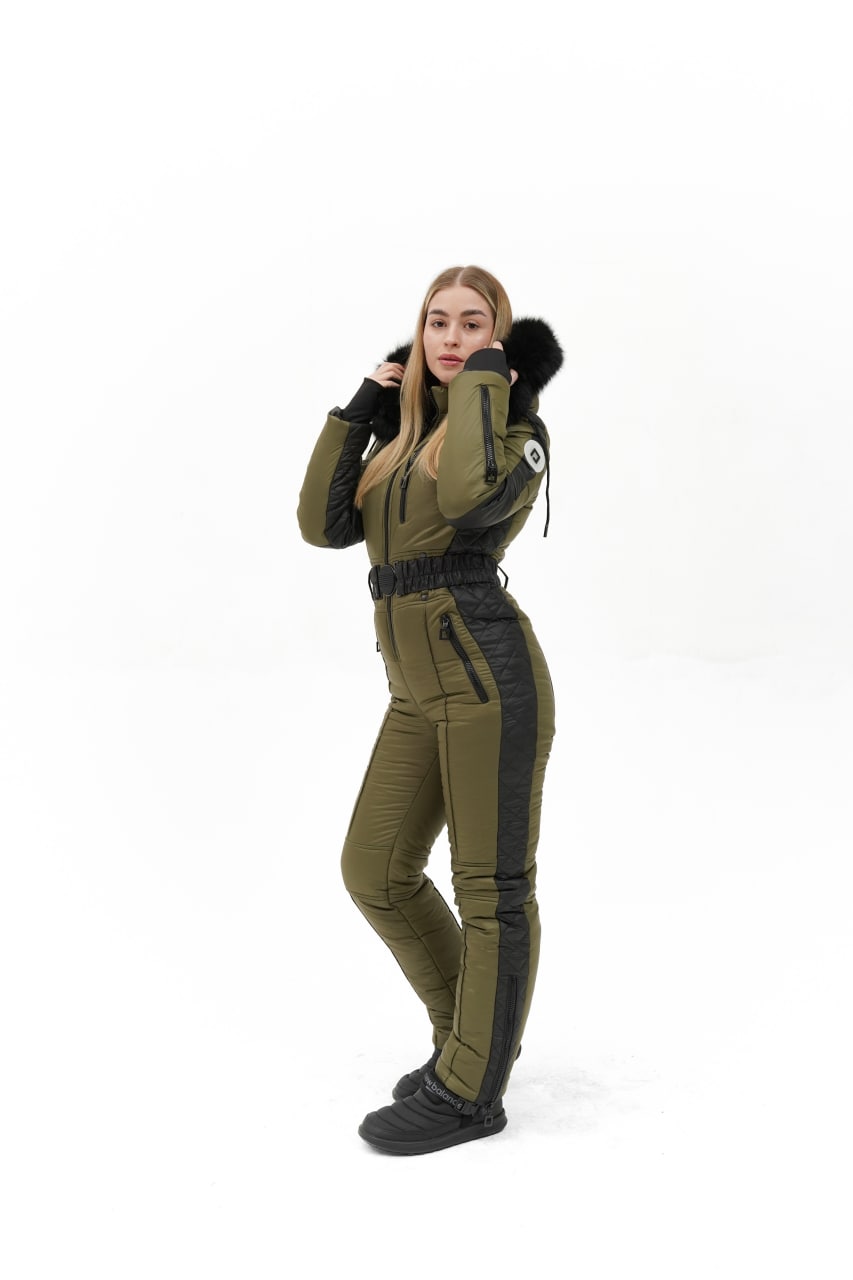 Person wearing a green and black jumpsuit on a white background