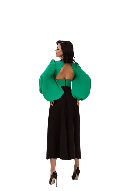 Woman wearing a green open-back top and black skirt on a white background