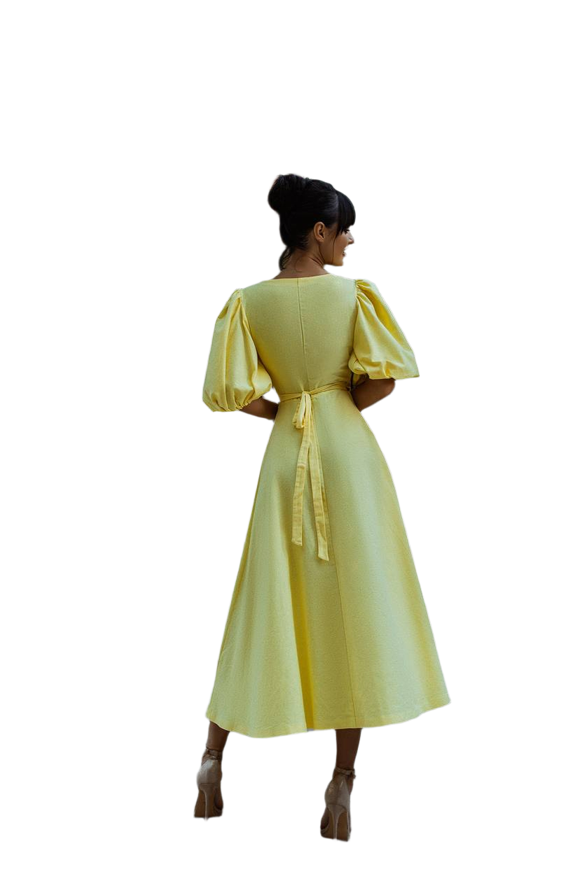 Woman wearing a yellow dress with puffed sleeves on a white background
