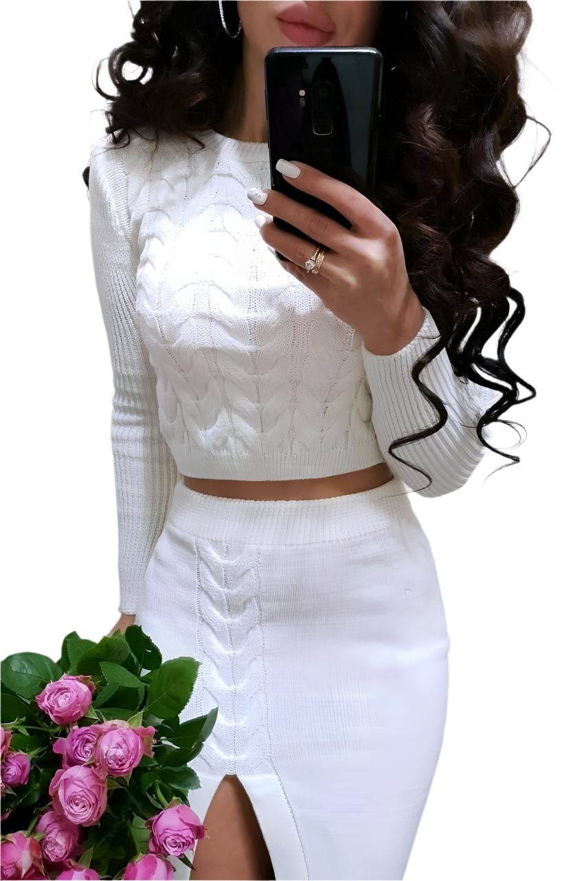 Person wearing a white cable knit top and white skirt holding pink roses.