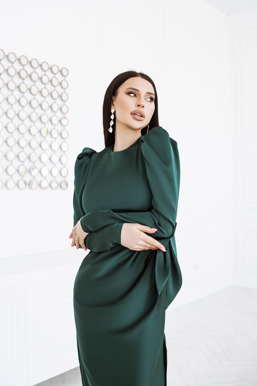 Woman wearing a green dress against a white background