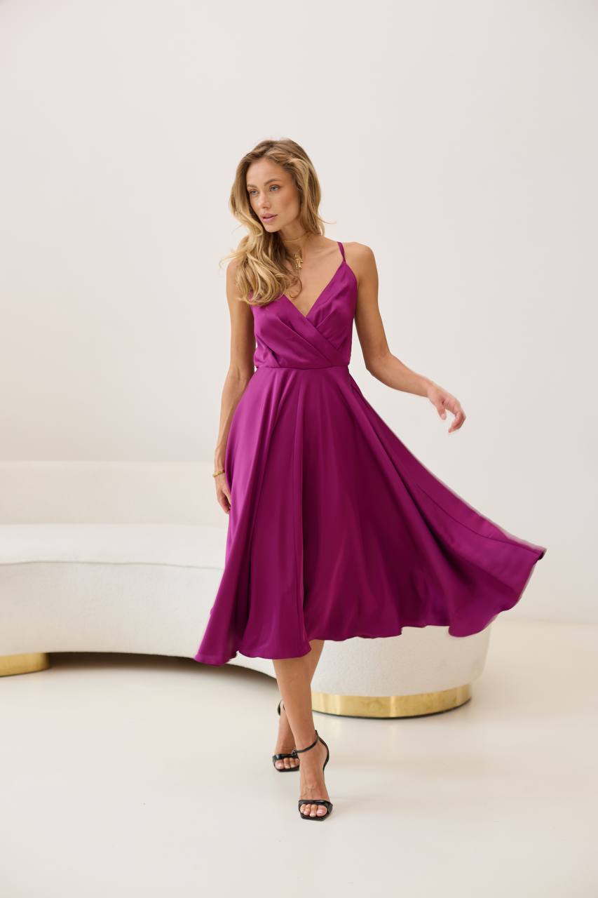 Woman wearing a purple dress in a minimalistic setting