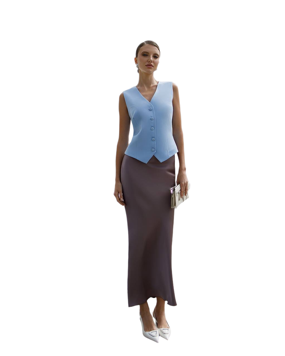 Woman wearing a light blue vest over a brown dress on a white background