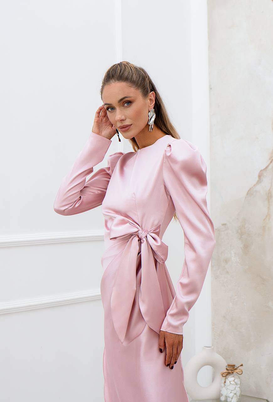 Woman wearing a pink satin dress with a white background