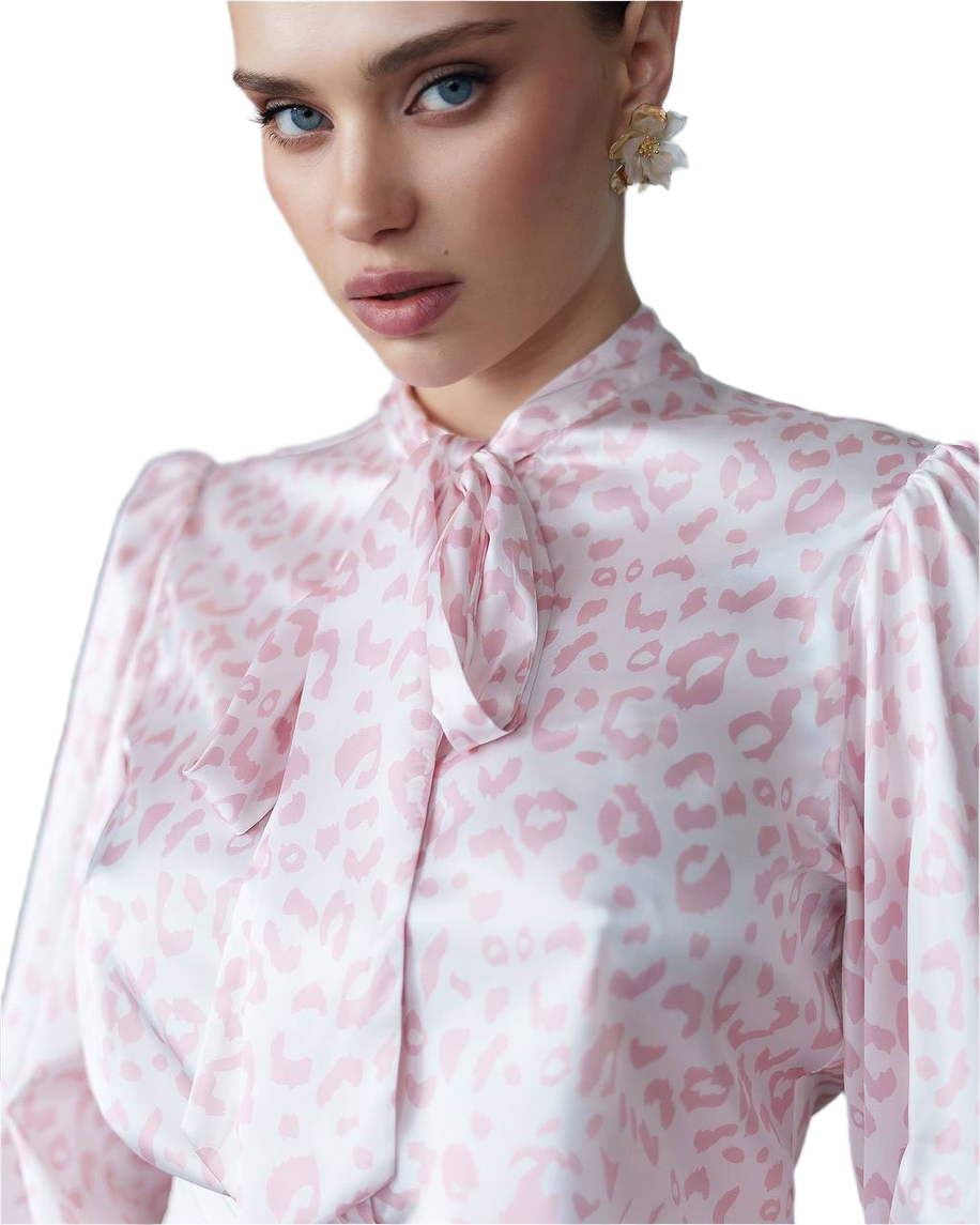 Woman wearing a pink leopard print blouse with a white background