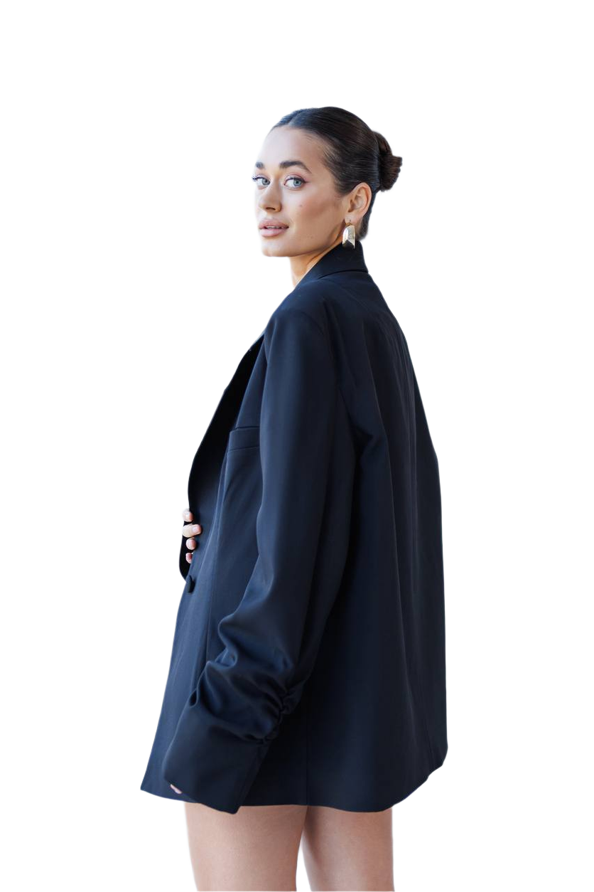Woman wearing a black blazer on a white background