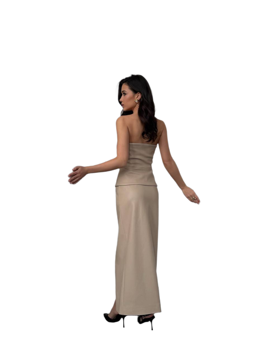 Woman wearing a beige strapless gown on a white background