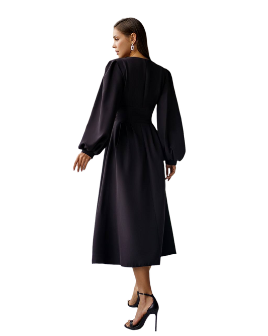 Woman wearing a black dress with long sleeves on a white background