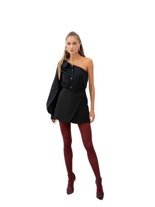 Woman wearing a black outfit with red tights on a white background