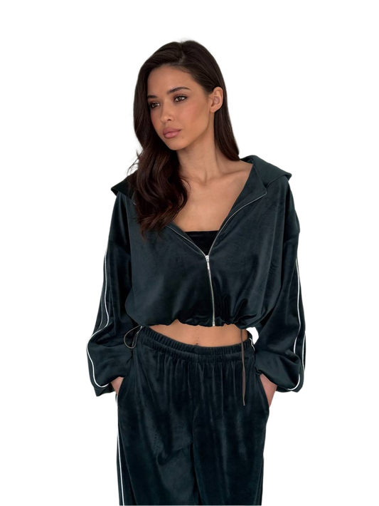 Woman wearing a dark green tracksuit with a hood on a white background