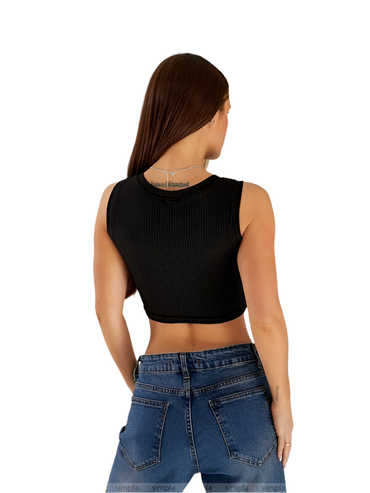 Person wearing a black sleeveless top and blue jeans on a white background