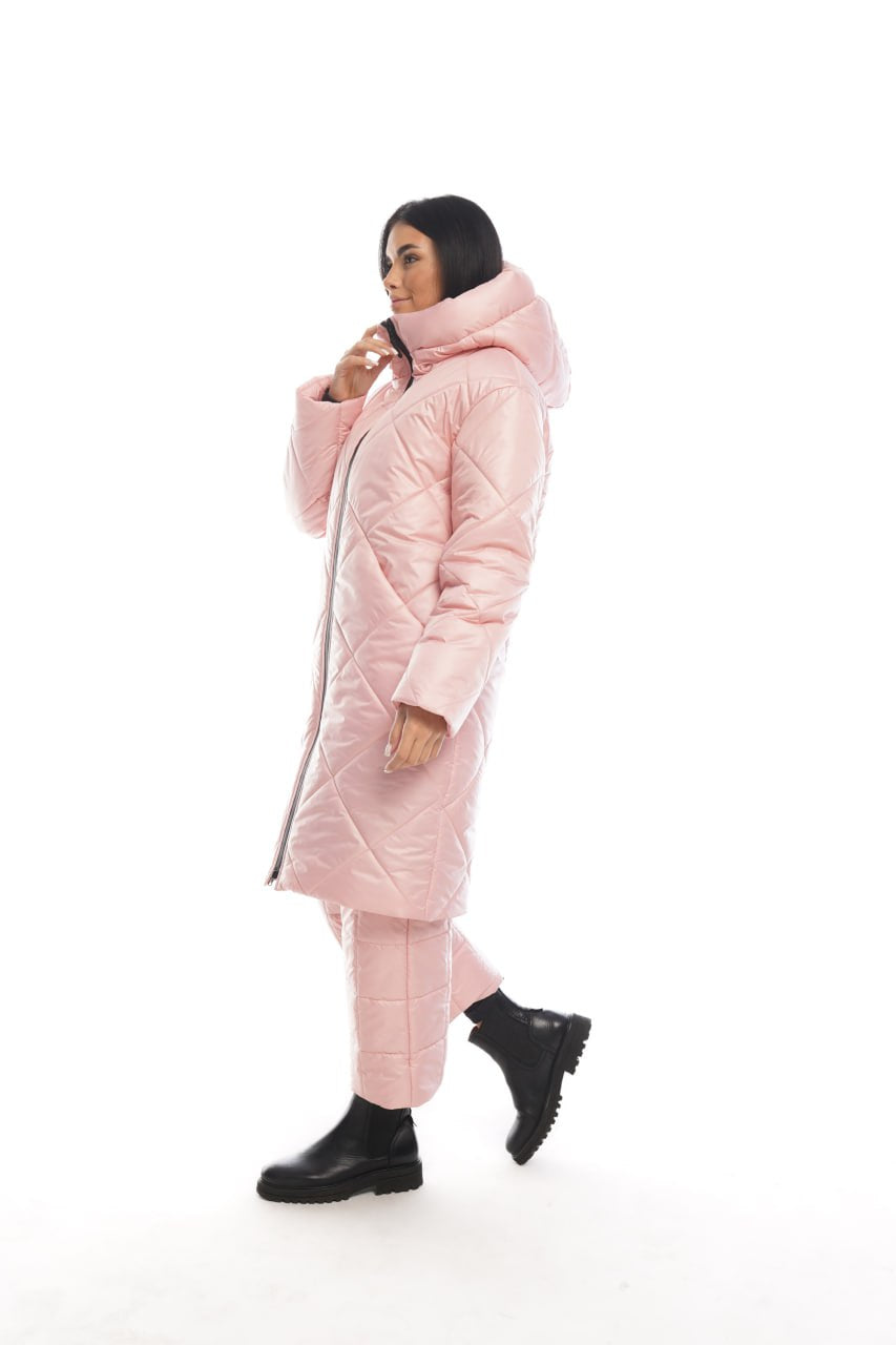 Person wearing a long pink puffer coat on a white background