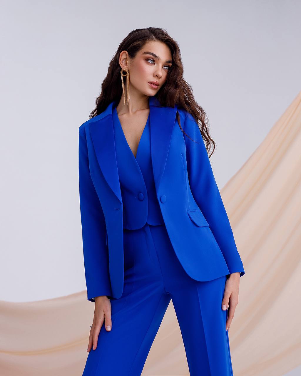 Woman wearing a blue suit against a neutral background