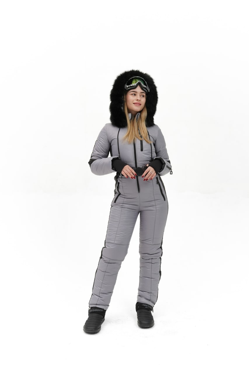 Person wearing a gray winter suit with a fur-lined hood on a white background