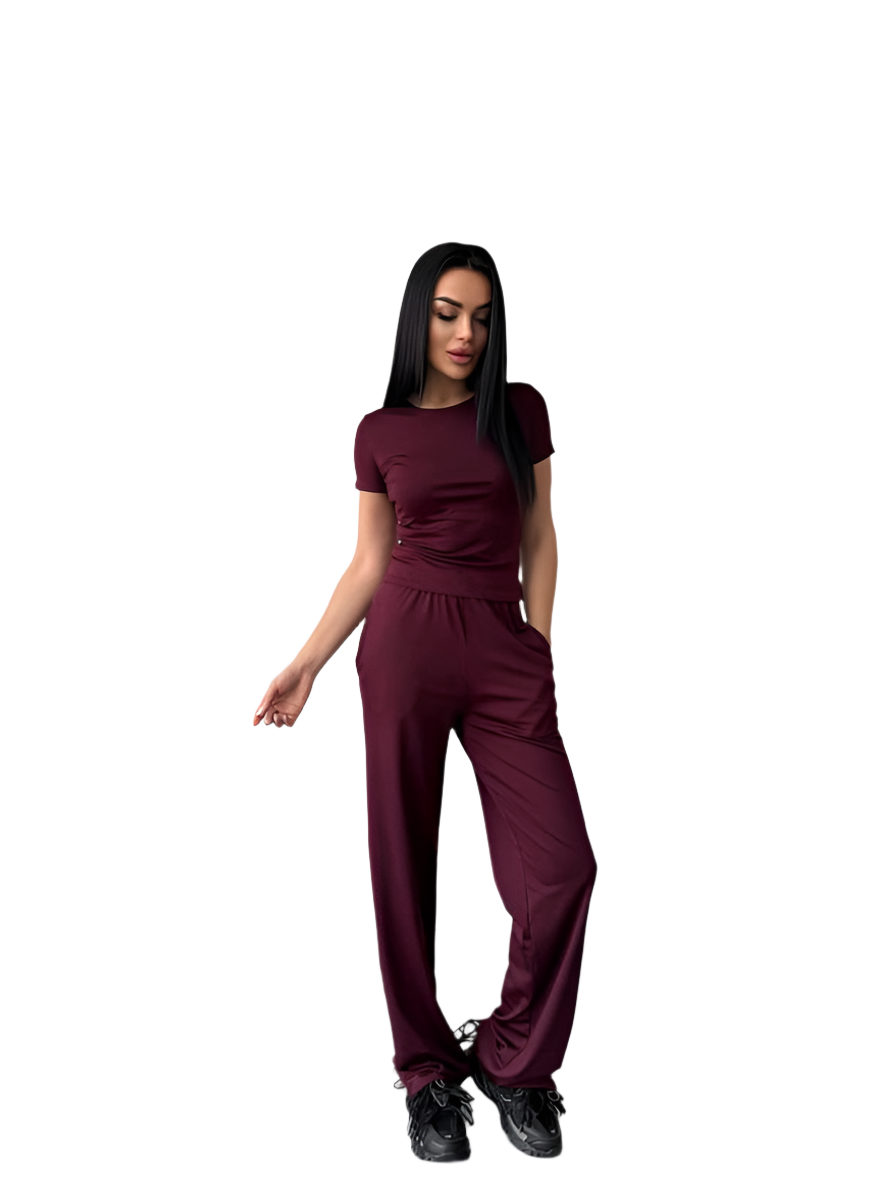Woman wearing a maroon jumpsuit on a white background