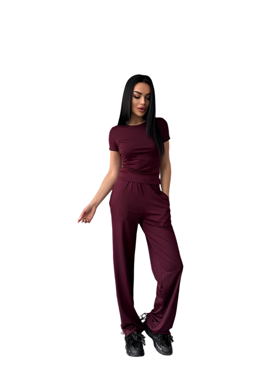 Woman wearing a maroon jumpsuit on a white background