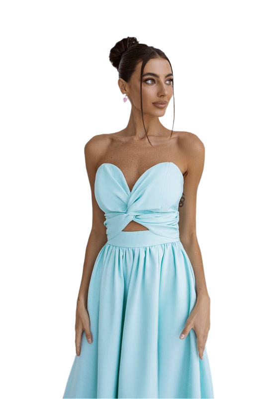 Woman wearing a light blue strapless dress with a cutout design on a white background