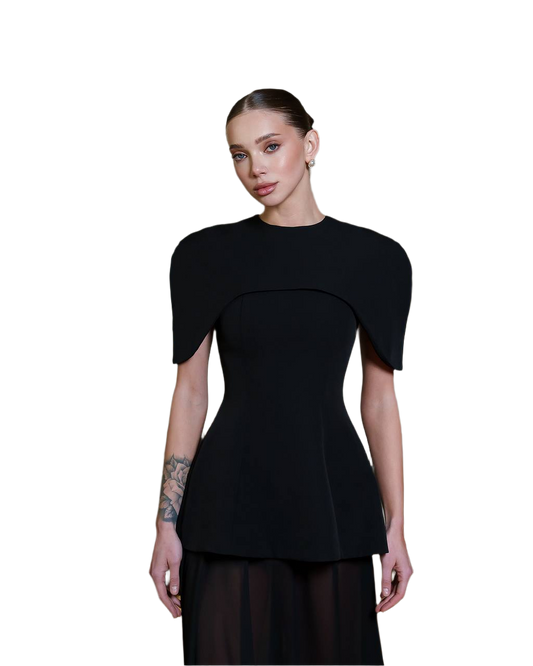 Woman wearing a black peplum top on a white background