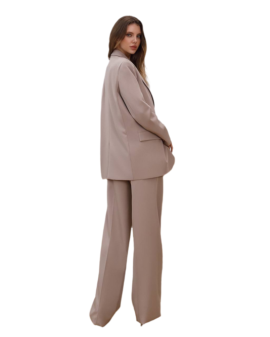 Woman wearing a beige suit on a white background
