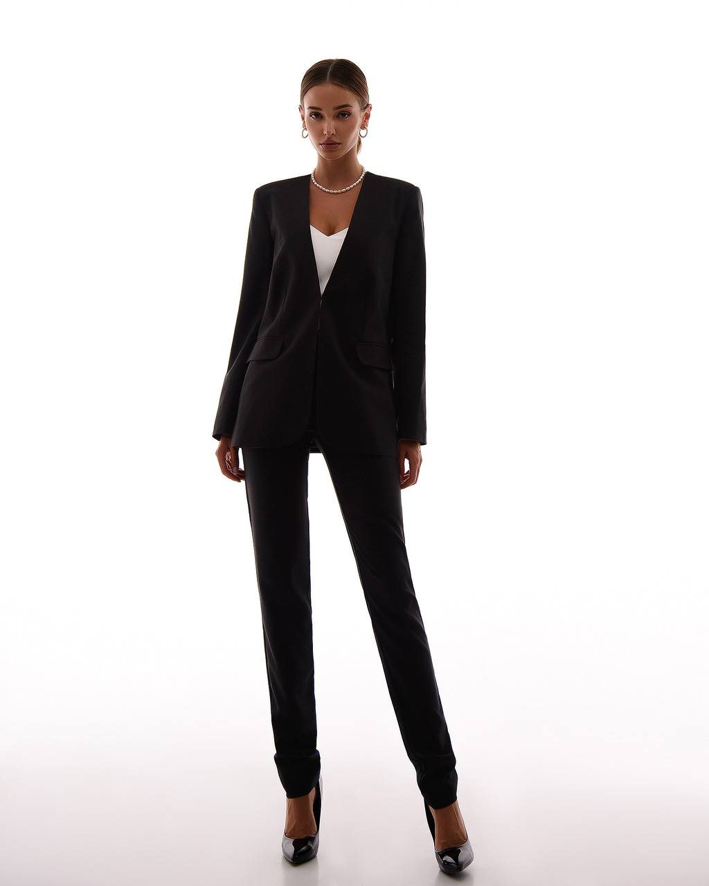 Woman wearing a black suit on a white background