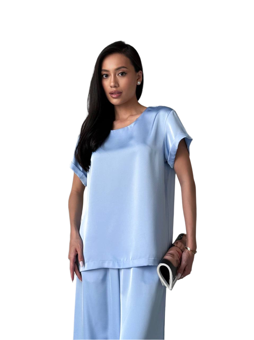 Woman wearing a light blue outfit on a white background