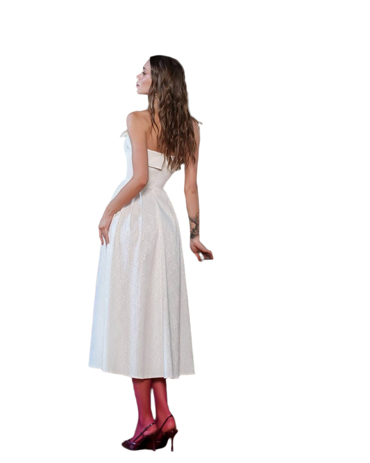 Woman wearing a white dress with red shoes on a white background