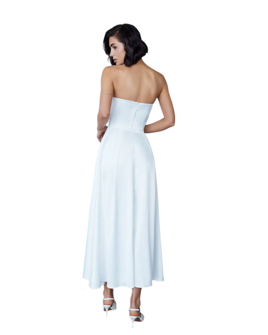 Woman wearing a strapless white dress on a white background