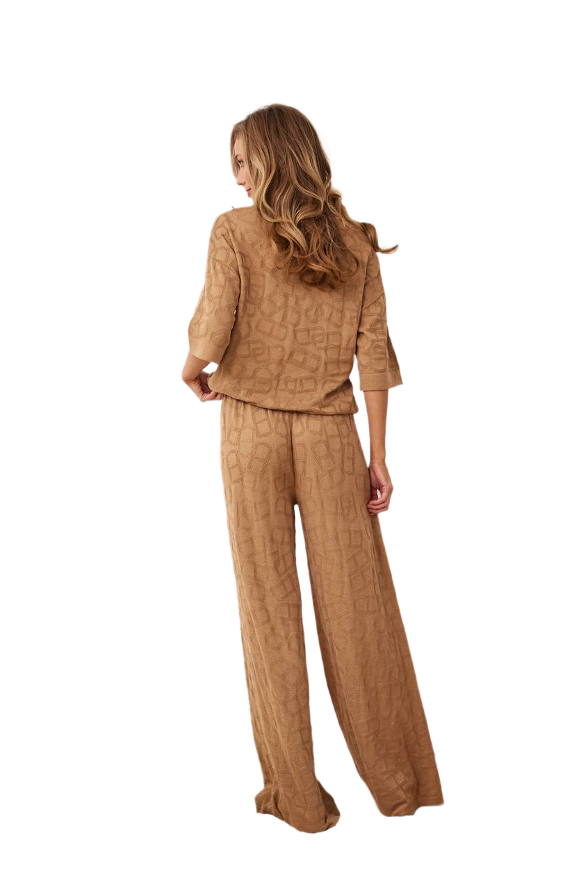 Woman wearing a brown textured outfit on a white background