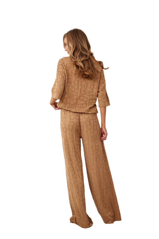 Woman wearing a brown textured outfit on a white background