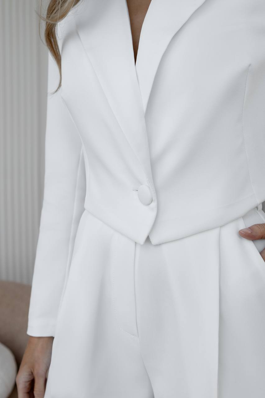 White coat worn by a person with a neutral background