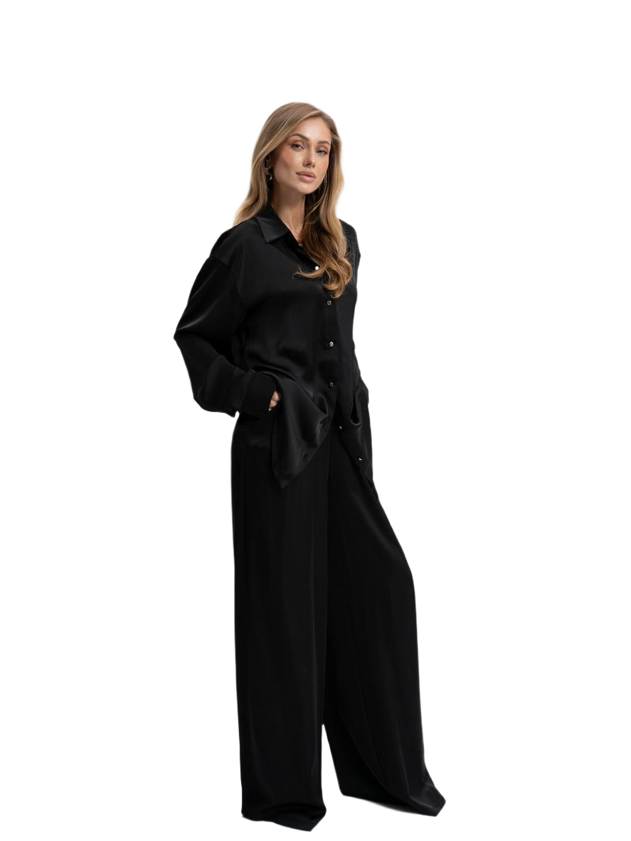 Woman wearing a black dress with a belt on a white background