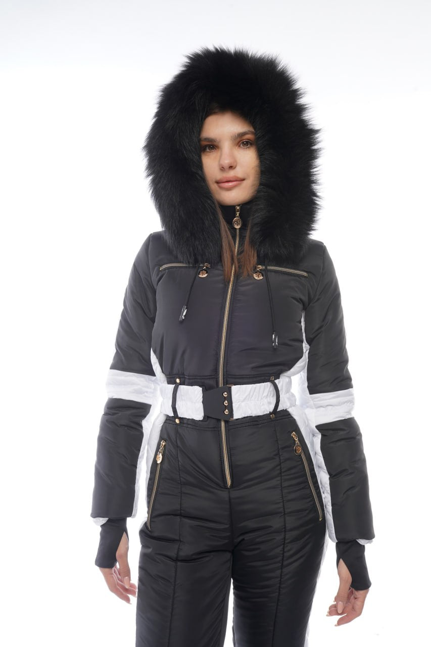 Woman wearing a black winter coat with fur hood on a white background