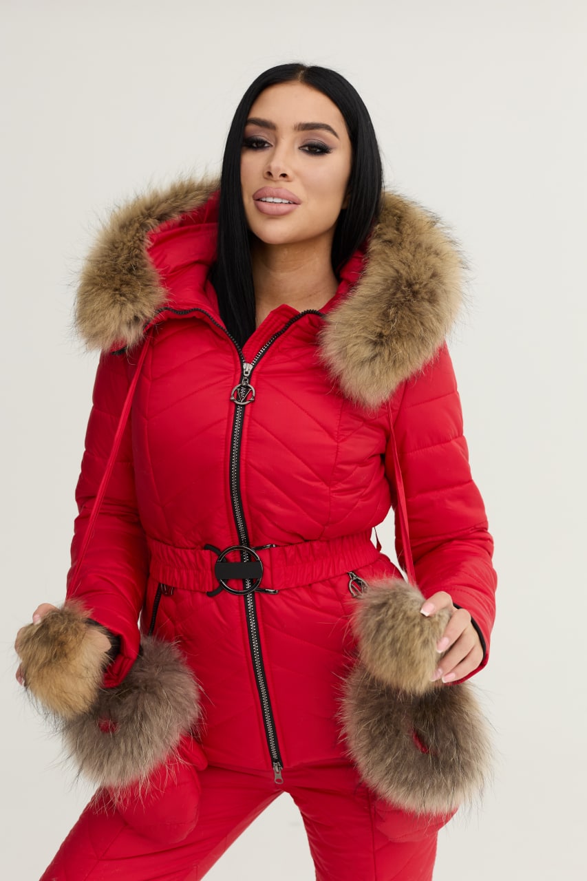 Woman wearing a red puffer suit with fur trim on a white background