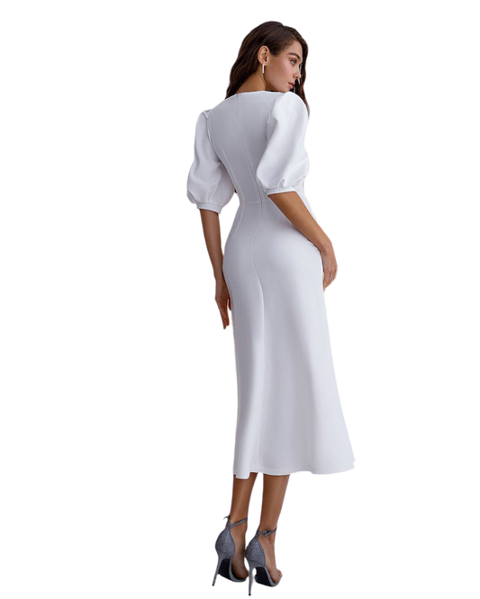 Woman wearing a white dress with puffed sleeves on a white background