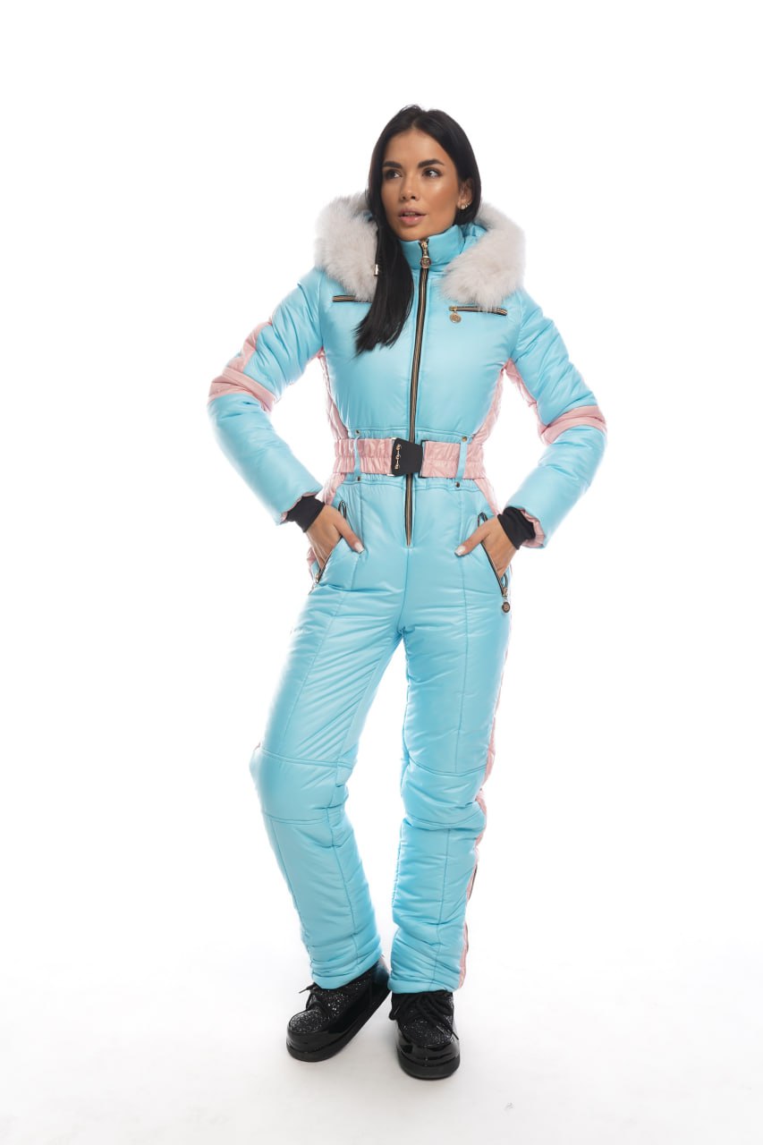Woman wearing a light blue snowsuit with white fur trim on a white background