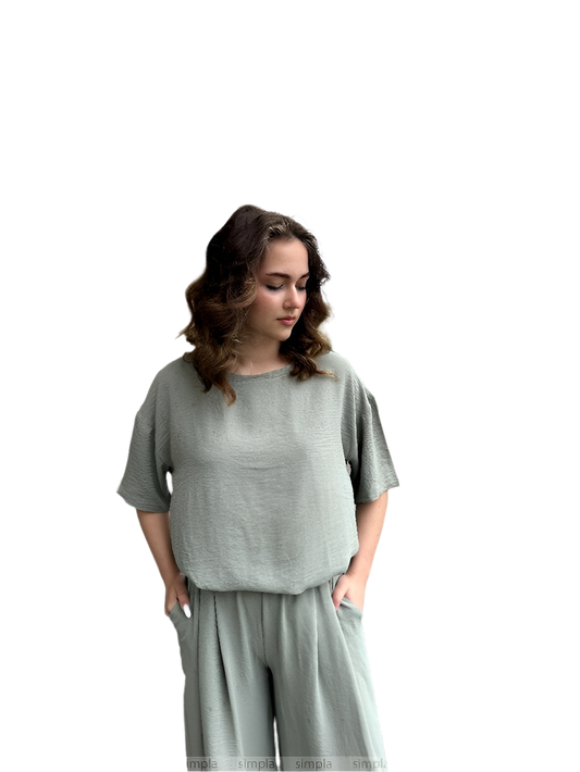 Woman wearing a gray outfit on a white background