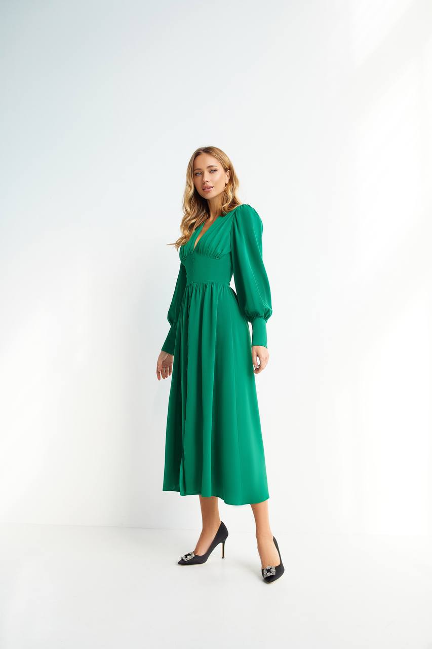 Woman wearing a green dress on a white background