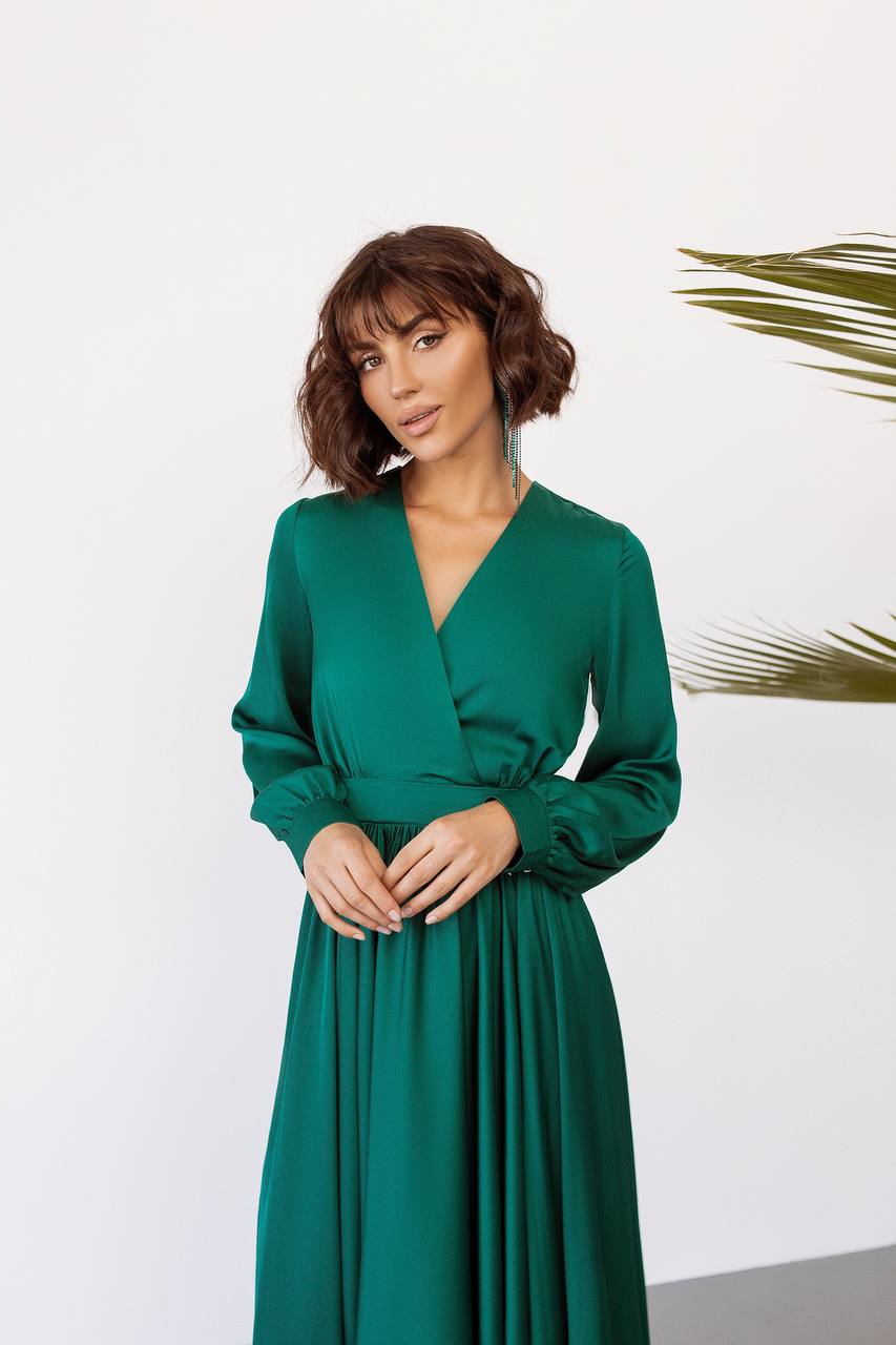 Woman wearing a green dress against a white background