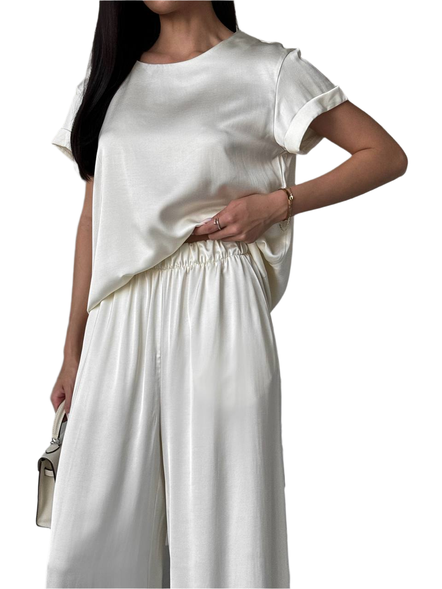 Woman wearing a white outfit with a plain background
