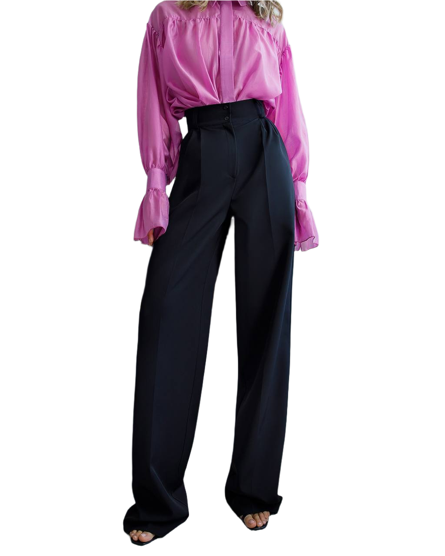 Person wearing a pink blouse and black pants on a white background