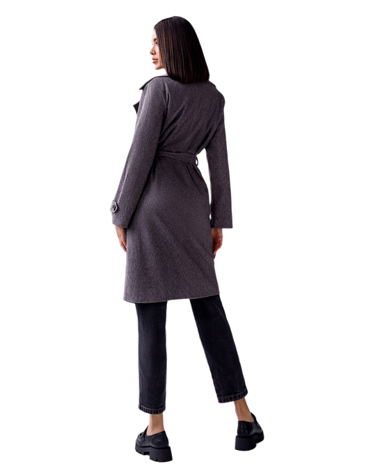 Woman wearing a gray coat on a white background