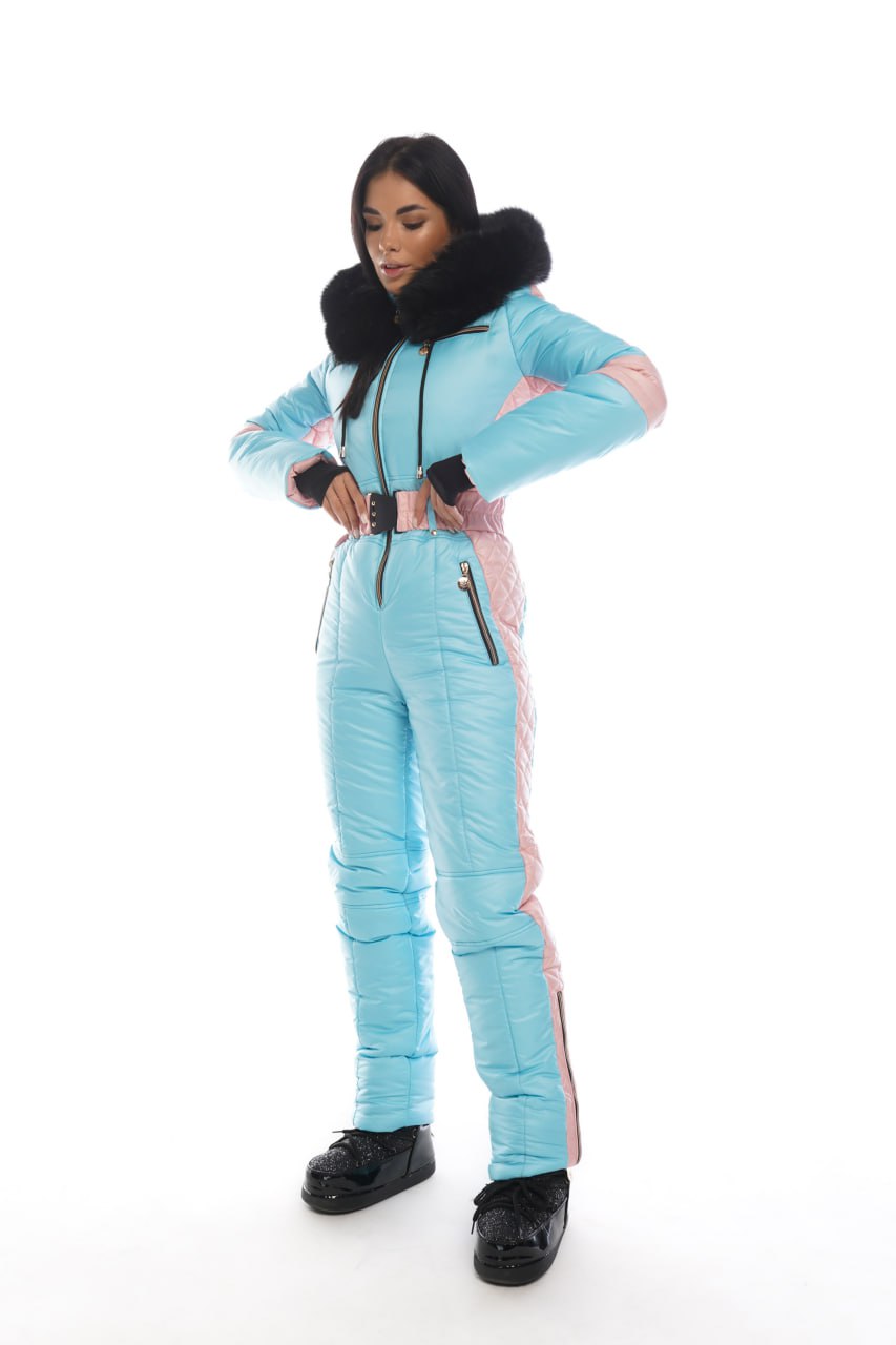 Person wearing a light blue snowsuit with black accents on a white background