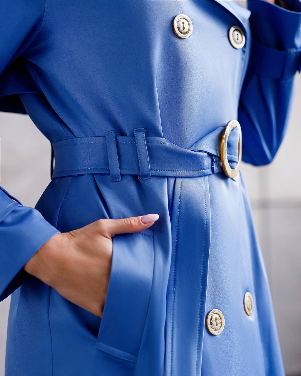 Blue coat with gold buttons and a belt, focusing on the waist area.