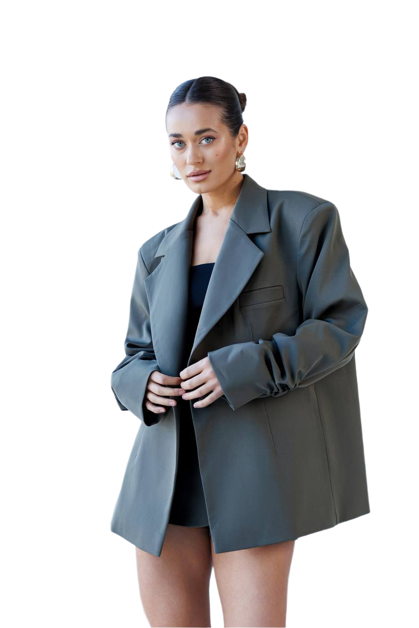 Woman wearing a gray blazer over a black top on a white background