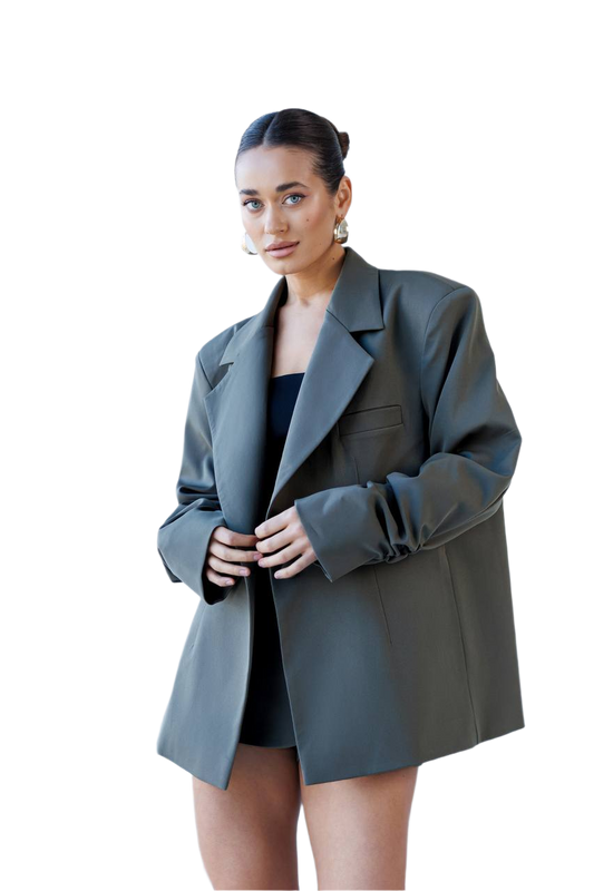 Woman wearing a gray blazer over a black top on a white background